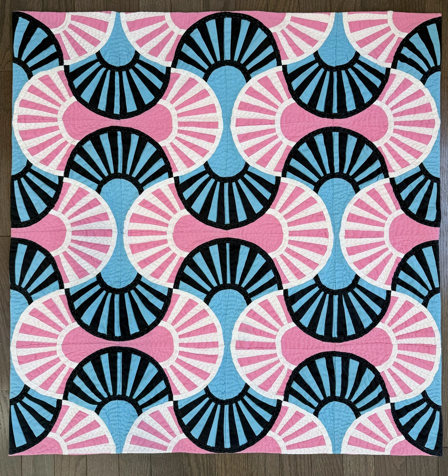 Pink and blue fan pattern quilt